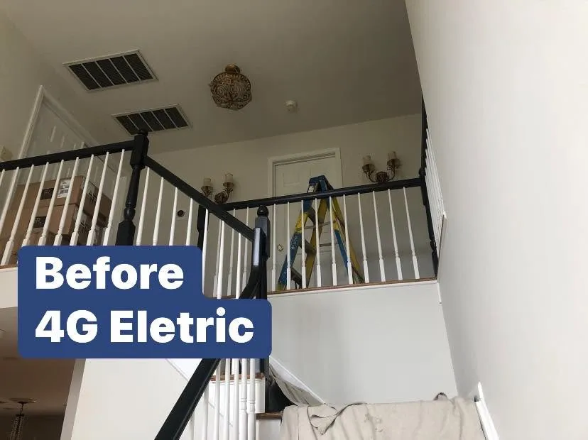 Two-story foyer before new lighting
